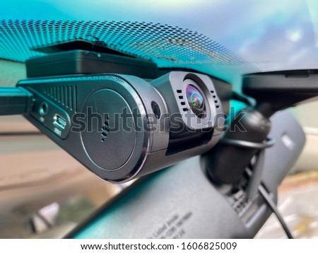 Close up of modern car dashcam attached to the windshied of the car. Royalty-Free Stock Photo #1606825009