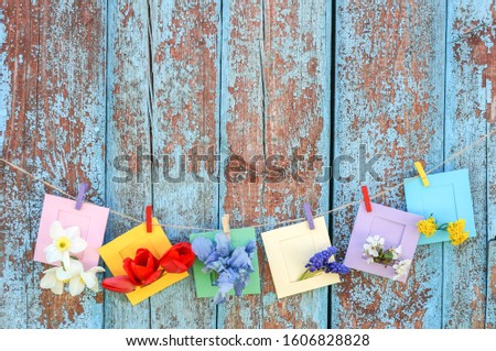 background with flowers in small envelop in grunge wooden wall	