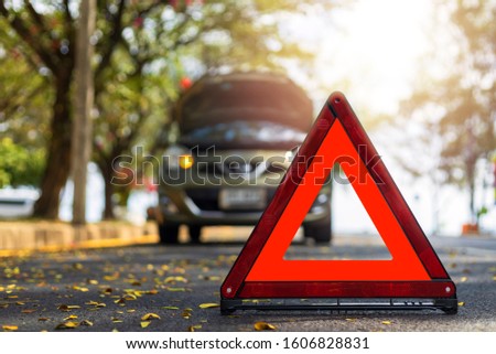 Red triangle, red emergency stop sign, red emergency symbol and  car stop and park on road.