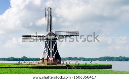 The old traditional mill in the Netherlands. Summer sunny landscape. Photo is perfect with copy space area for your text message.