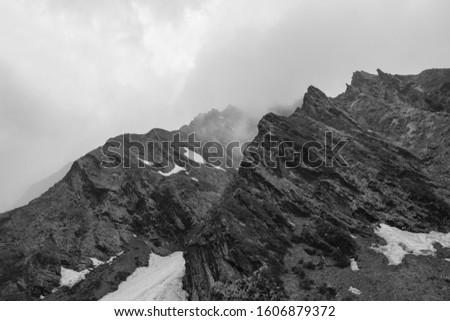Mountain ridges emerging from clouds