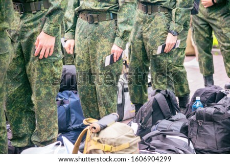 cadets conscripts in uniform stand in line with bags and backpacks Royalty-Free Stock Photo #1606904299