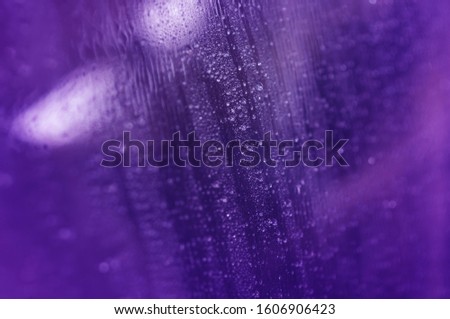 Rain drops blue on window glasses  with cloudy background.rain bubbles car . Natural Pattern of raindrops on cloudy background.
