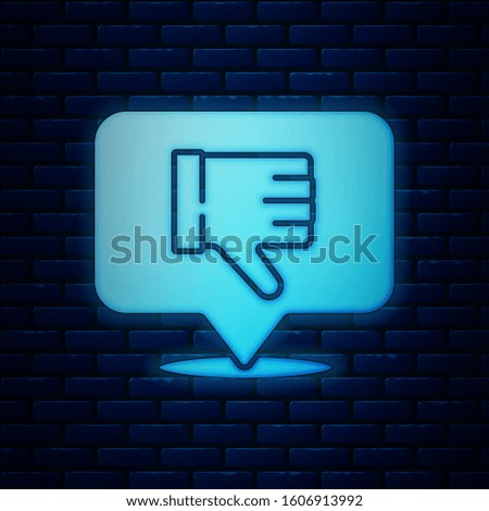Glowing neon Dislike in speech bubble icon isolated on brick wall background.  Vector Illustration