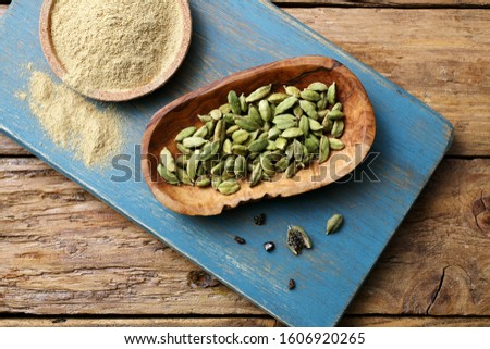 cardamon seed and powder background Royalty-Free Stock Photo #1606920265