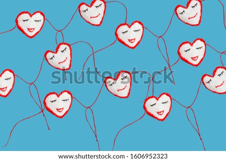 Valentine's Day background. Funny hearts smiling and holding hands