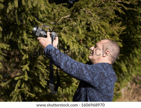 Photographer shooting a macro scene outdoor in the forest
