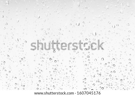 Waterdrops background on a window. White texture of rain Royalty-Free Stock Photo #1607045176