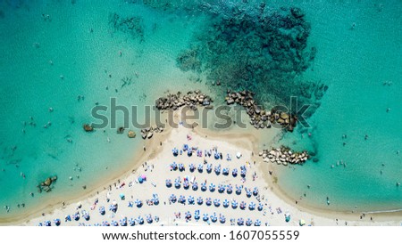 Cyprus holiday. Cyprus beach drone above. Beach umbrellas, Mediterranean sea Royalty-Free Stock Photo #1607055559