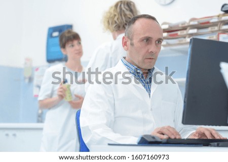 doctor checking results in his computer