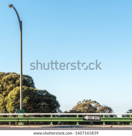 One Way Sign and Lamp Post