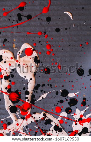 Picture painted using the technique of dripping. Mixing different colors red white black. Lines and spots. Vertical orientation.