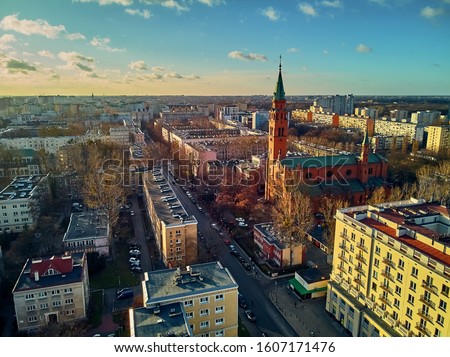 Beautiful panoramic aerial drone view to the St. Augustine's Church in in the rays of the setting winter January sun - amazing sunset, Warsaw, Poland