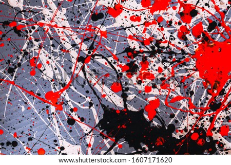 Picture painted using the technique of dripping. Mixing different colors red white black. Lines and spots. Horizontal orientation.