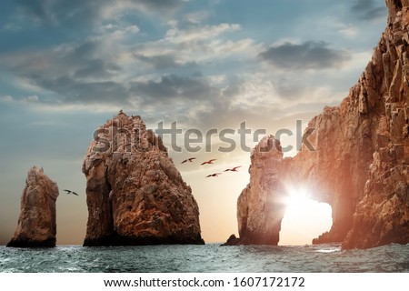 Rocky formations on a sunset background. Famous arches of Los Cabos. Mexico. Baja California Sur. Royalty-Free Stock Photo #1607172172