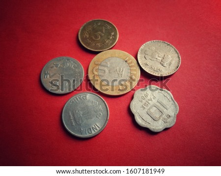 Close up indian currency isolated on red background, top view of indian rupee circulating coins collection set,old and new