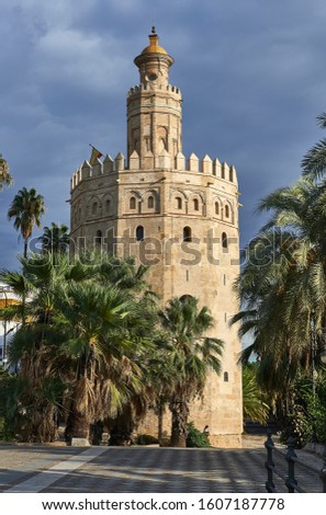 The Torre del Oro among palm trees in Seville