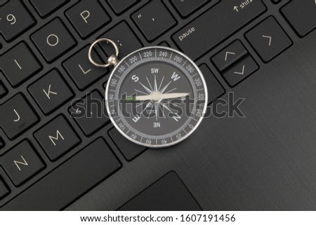 Laptop computer keyboard and compass, internet navigation concept