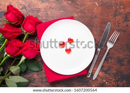 Valentines day table setting empty plate and red roses on wooden background. Top view. Valentine's greeting card - Image