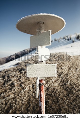 signpost in the snowy mountains, high road