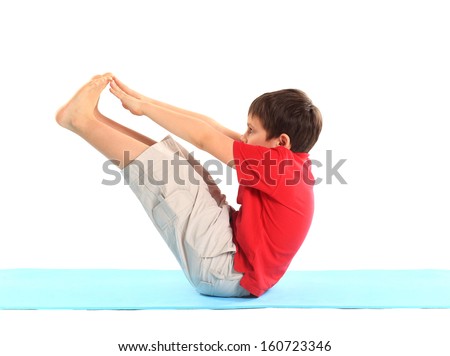Children's yoga. The little boy does exercise.
