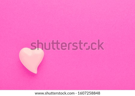 pink background with a heart and with copy space