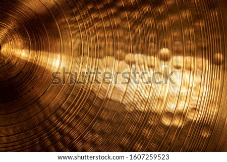 Extreme close-up of an old golden cymbal of drum kit. Percussion instrument Royalty-Free Stock Photo #1607259523