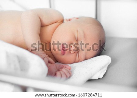 pretty newborn baby with tag on hand
