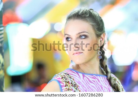 contemporary young woman on blurred festive background