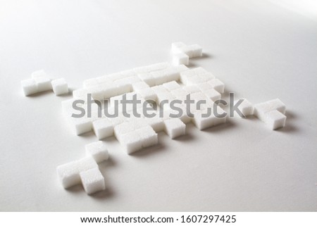 pixel art skull made out of sugar cubes on a white background symbolizing unhealthy food