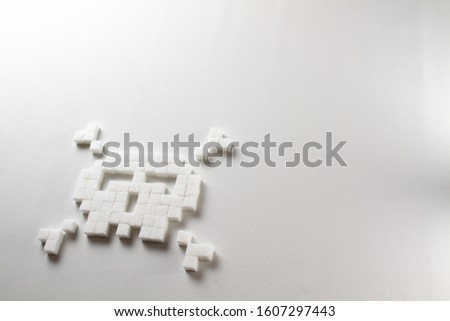pixel art skull made out of sugar cubes on a white background symbolizing unhealthy food