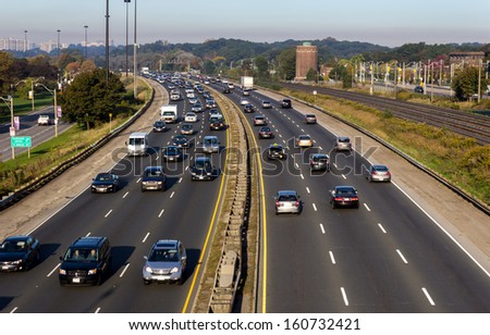 Busy highway during the day with number plates and car logos removed Royalty-Free Stock Photo #160732421