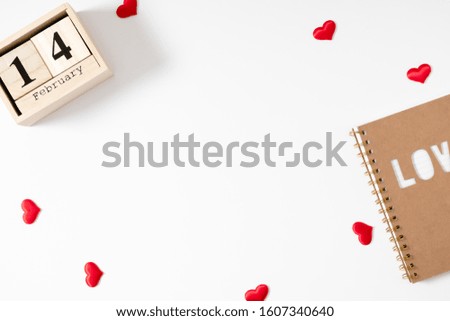 Valentines Day minimum background. February 14 date wooden block calendar, red heart on white background. Flat lay, top view, copy space