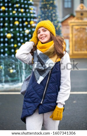 Closeup portrait of a young beautiful girl in winter park