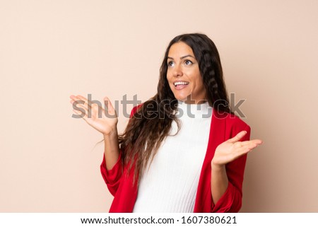 Young woman over isolated background with surprise facial expression