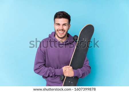 Young caucasian skater man isolated laughing and having fun.