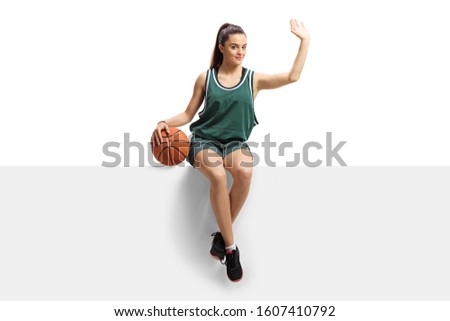 Female basketball player sitting on a panel and waving isolated on white background