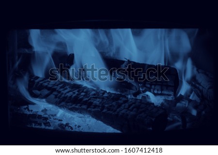 Fire in the fireplace full frame classic blue toned