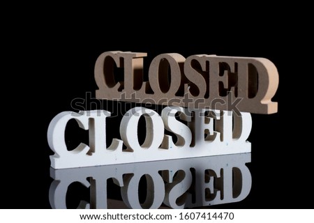 "Closed" wooden sign board for business. Black background. Mock up product. 