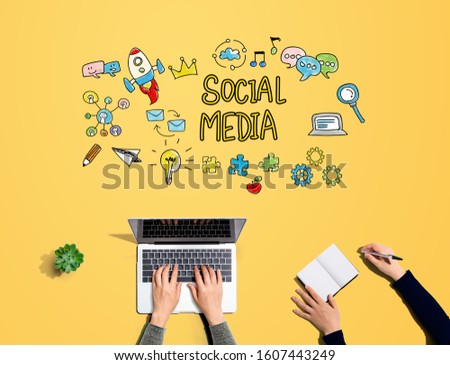Social media with people working together with laptop and notebook