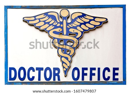 Somewhat weathered and dirty Caduceus DOCTOR OFFICE sign.