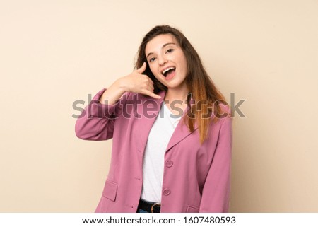 Young brunette girl with blazer over isolated background making phone gesture. Call me back sign