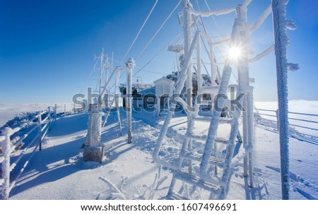 weather station in winter landscape. Ceahlau, Romania Royalty-Free Stock Photo #1607496691