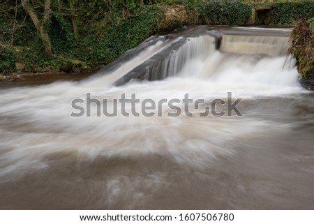 Long exposure of a waterfall on the river Avill in Dunster in Somerset