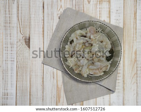XE salad of freshly salted fish with olive oil on a wooden white rustic background or table. Ready to eat. Royalty-Free Stock Photo #1607512726
