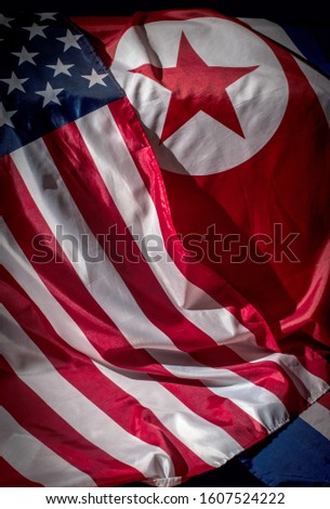 Closeup of flags of North Korea and USA 