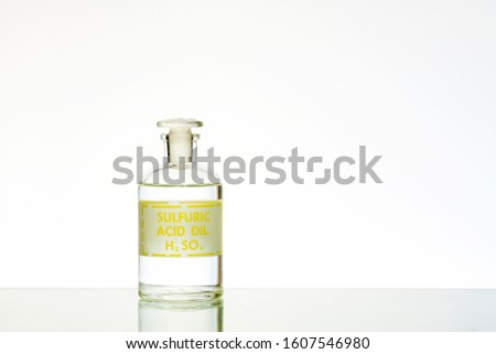 Bottle containing sulfuric acid, also called battery acid. Royalty-Free Stock Photo #1607546980