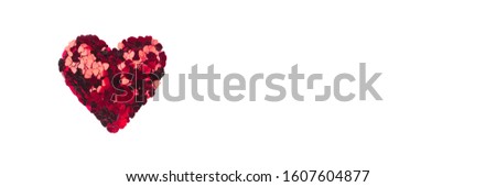 Heart of small red hearts isolated on a white background. Valentine's day concept. Flat lay, top view.