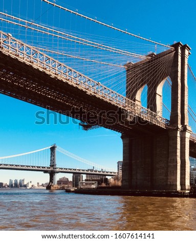 Brooklyn Bridge towering over Hudson river