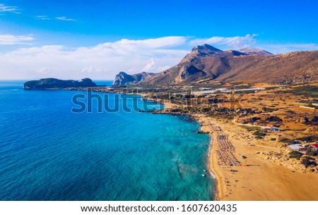 Aerial shot of beautiful turquoise beach Falasarna (Falassarna) in Crete, Greece. View of famous paradise sandy deep turquoise beach of Falasarna (Falassarna) in North West, Crete island, Greece. Royalty-Free Stock Photo #1607620435
